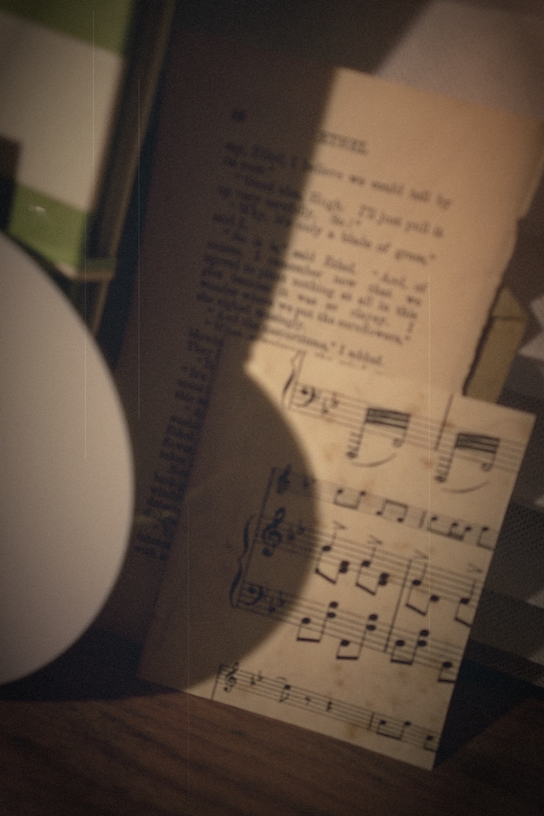 Piano Distance — antique sheet music in raking light, beside the handmade CD insert.